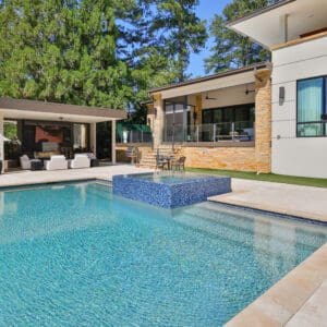 Modern pool and patio with blue tile.