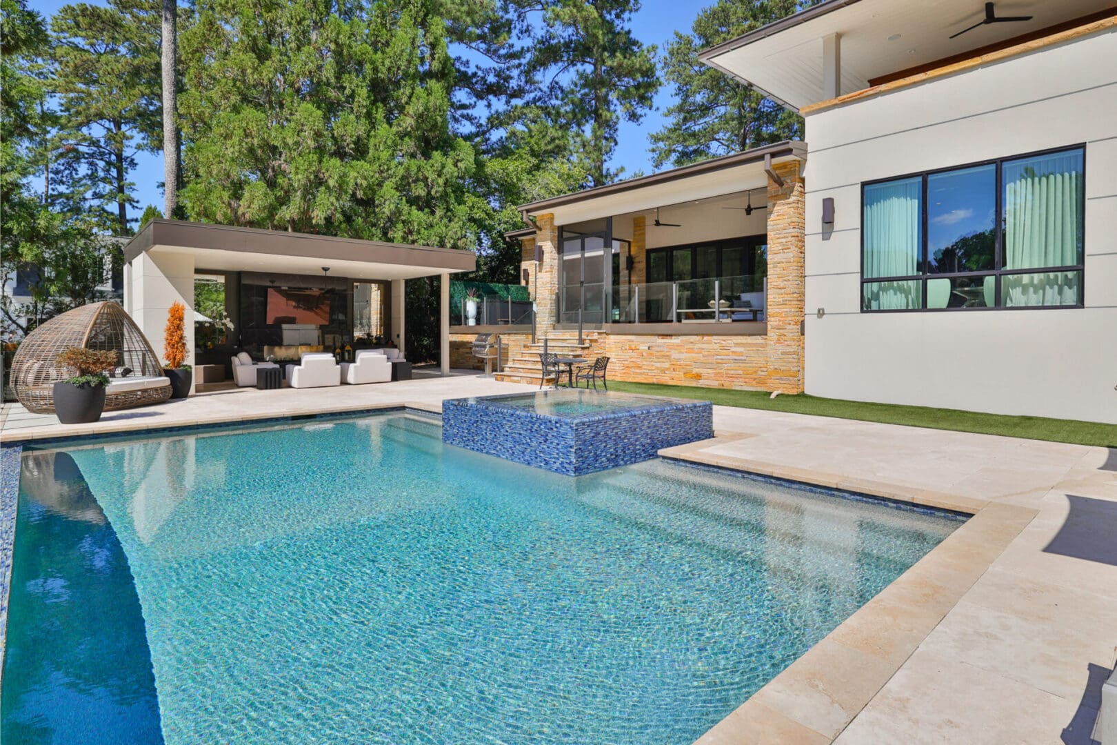 Modern pool and patio with blue tile.